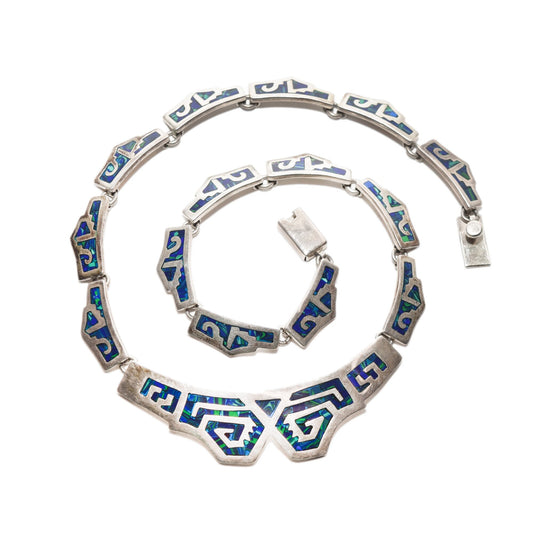 Modernist TAXCO sterling silver collar necklace with blue and green mosaic tribal design against a white background, 17.5 inches long.