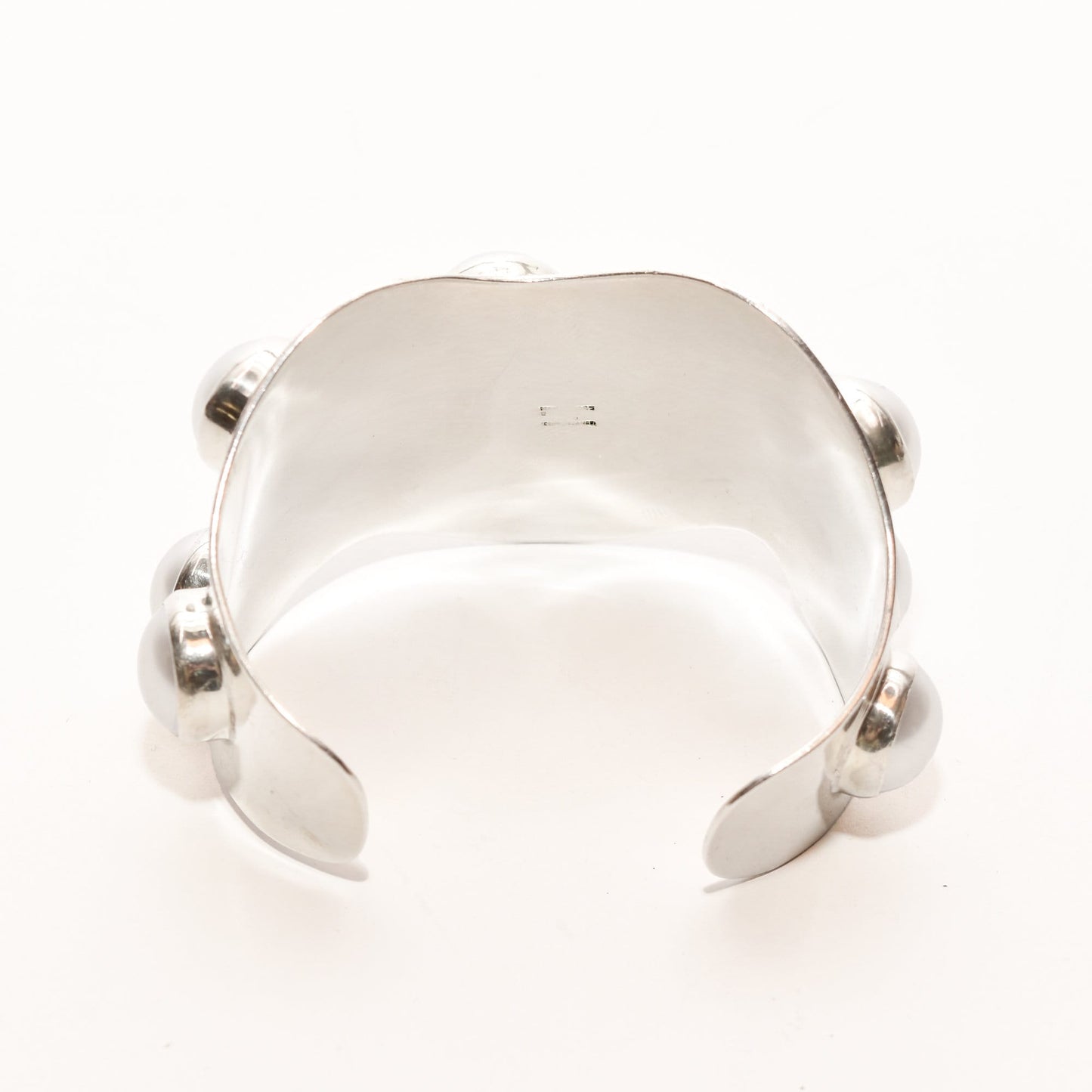 TAXCO Modernist sterling silver cuff bracelet with Mabe pearl, featuring a wide wavy design and sized at 5.75 inches, displayed against a white background.