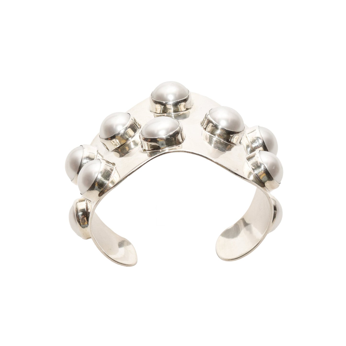 TAXCO modernist sterling silver mabe pearl cuff bracelet with a wide wavy design, statement jewelry piece measuring 5.75 inches, isolated on white background.