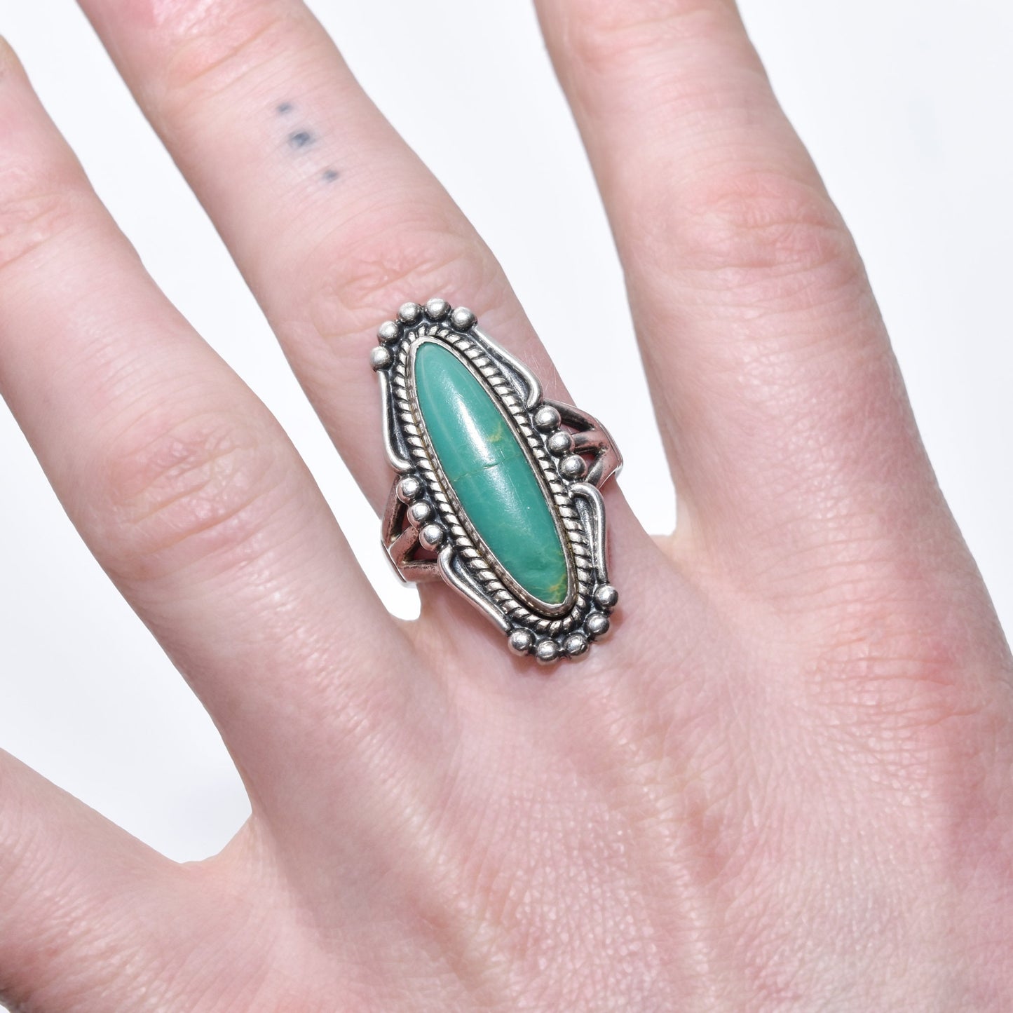 Native American sterling silver turquoise marquise ring on a hand, southwestern jewelry size 8 US