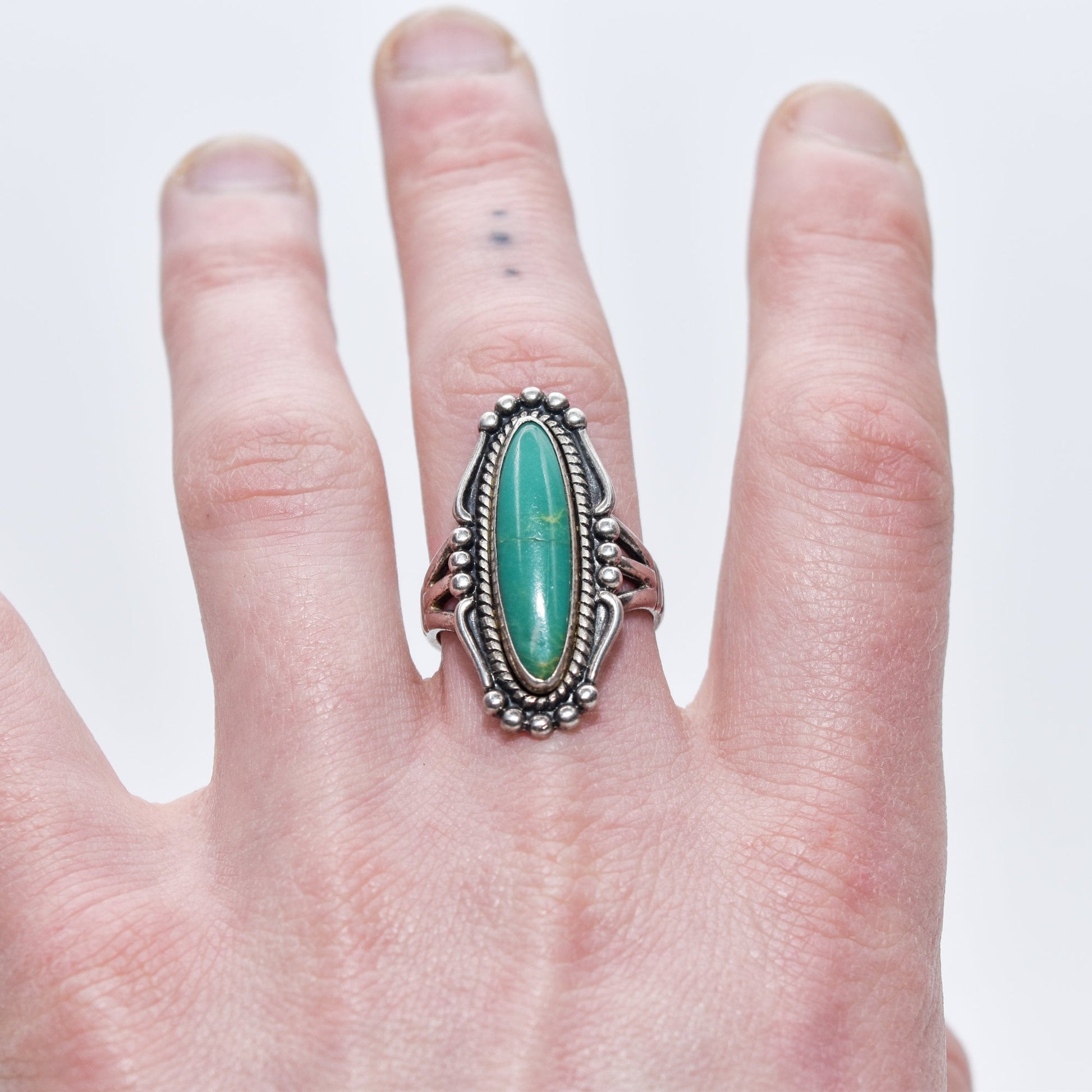 Native American sterling silver turquoise marquise ring showcased on a finger, size 8 US, with Southwestern jewelry design details.