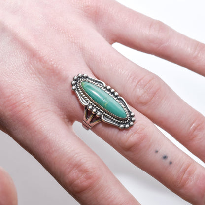 Native American sterling silver turquoise marquise ring on a finger, size 8 US, with detailed Southwestern jewelry design.