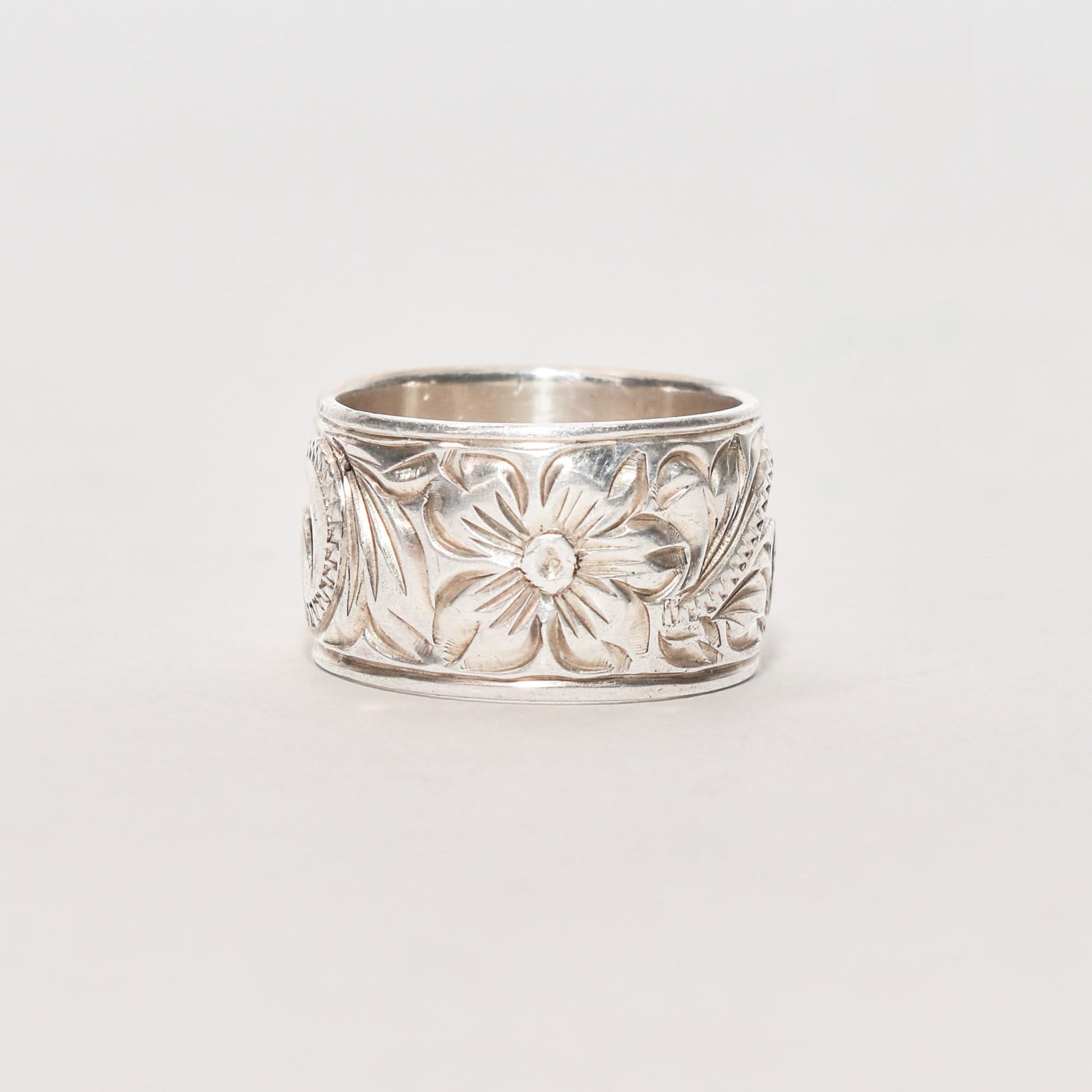 Floral-engraved sterling silver band ring, 11.5mm wide with Art Nouveau revival style design, size 6 US, displayed against a neutral background.